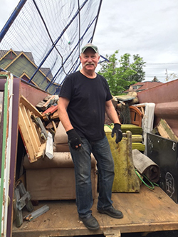 York Neighborhood Association Treasurer Cory Anderson helps out during Dumpster Day 2017